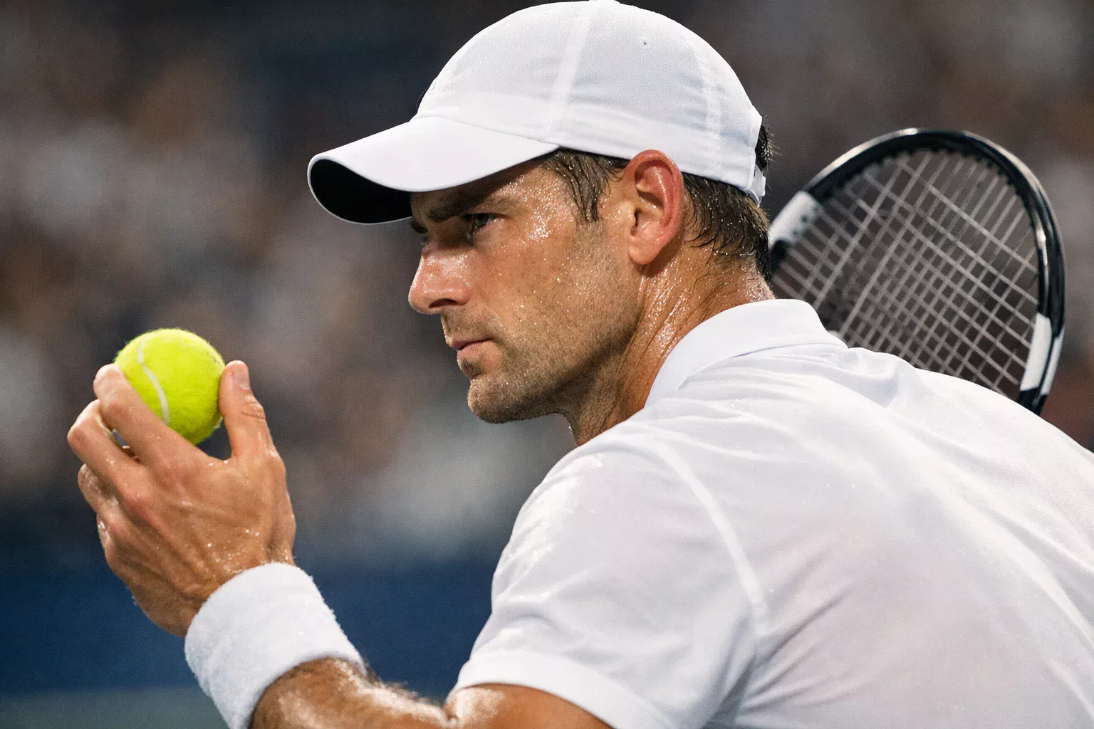 Tenista concentrado preparándose para un saque en Grand Slam